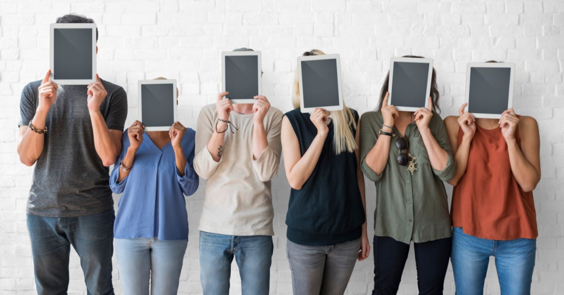 Group of people with tablets in front of faces identity resolution